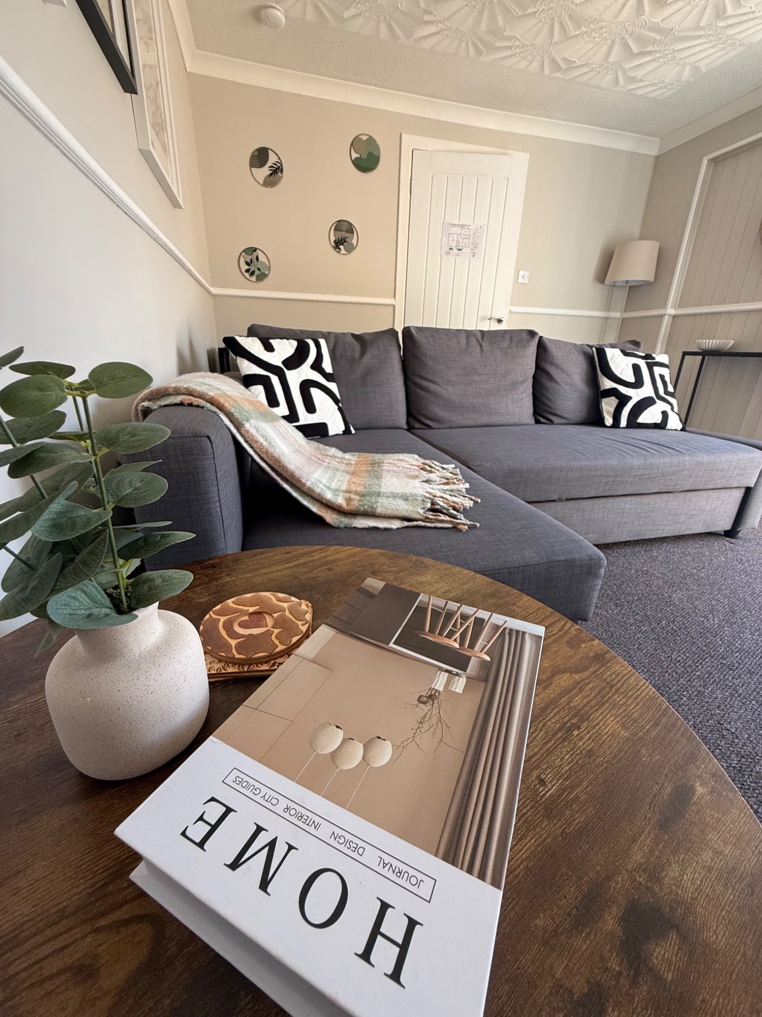 Comfortable living room at Bennison Square with grey corner sofa and coffee table